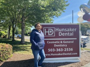 Patient outside of Hunsaker standing in front of Advertised sign, in Salem and Monmouth Oregon